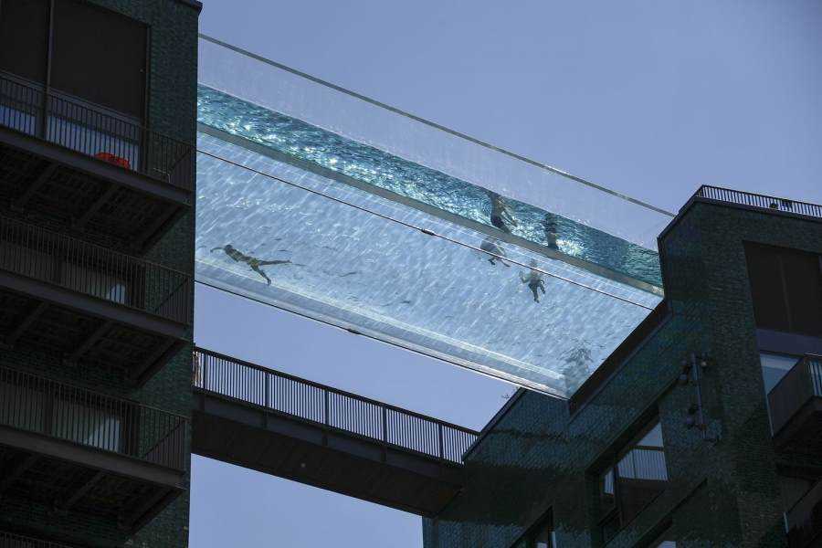 Swimmers enjoy world’s first crystal-clear Sky Pool, but its restricted from some residents Photograph